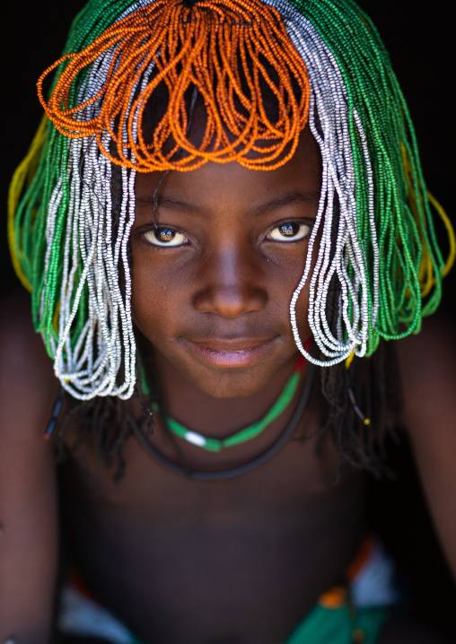 Muhakaona tribe girl with a beaded wig used for the fico ceremony, Cunene Province, Oncocua, Angola