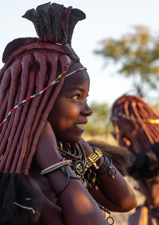 Himba tribe woman with a ray of light on her face, Cunene Province, Oncocua, Angola