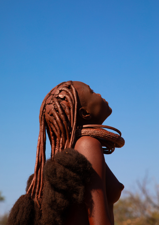 Batwa tribe woman looking up in the sky, Cunene Province, Oncocua, Angola