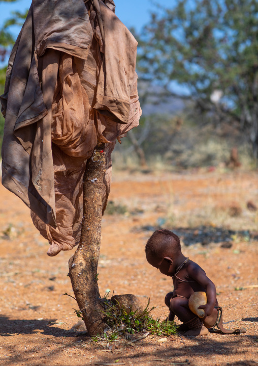 Batwa tribe child in front of a tree, Cunene Province, Oncocua, Angola