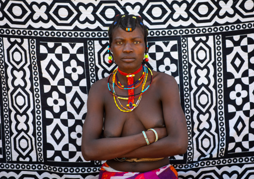 Portrait of a mudimba tribe woman in front of a printed cloth, Cunene Province, Cahama, Angola