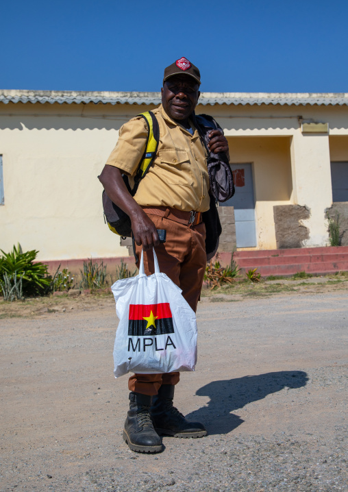 Angolan man holding a mpla plastic bag in the street, Huila Province, Lubango, Angola
