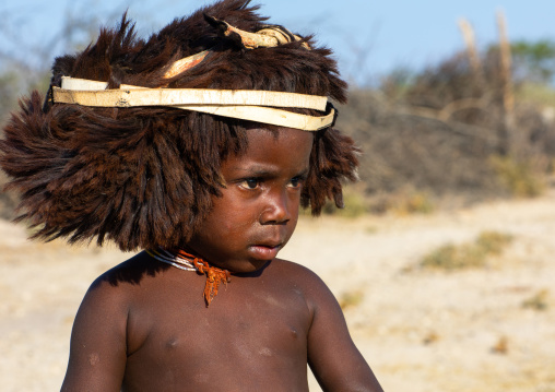 Cute mucubal tribe boy wearing a fur headwear, Namibe Province, Virei, Angola