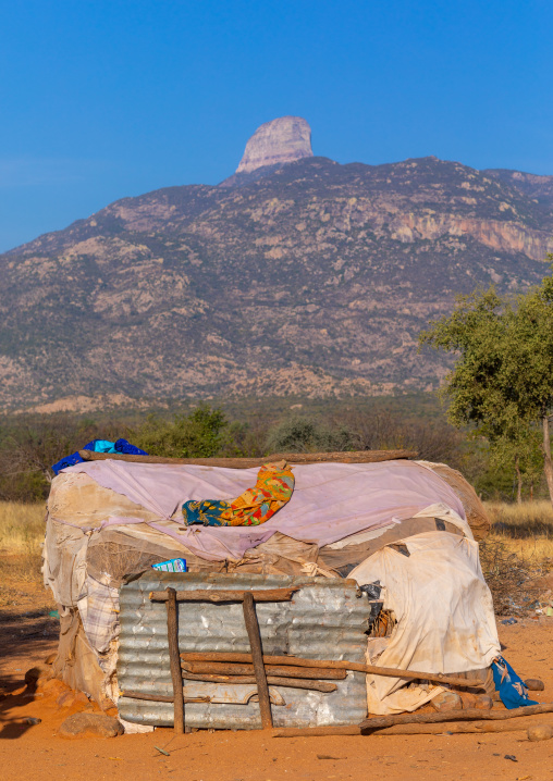 Hut in front of a rock formation, Namibe Province, Capangombe, Angola