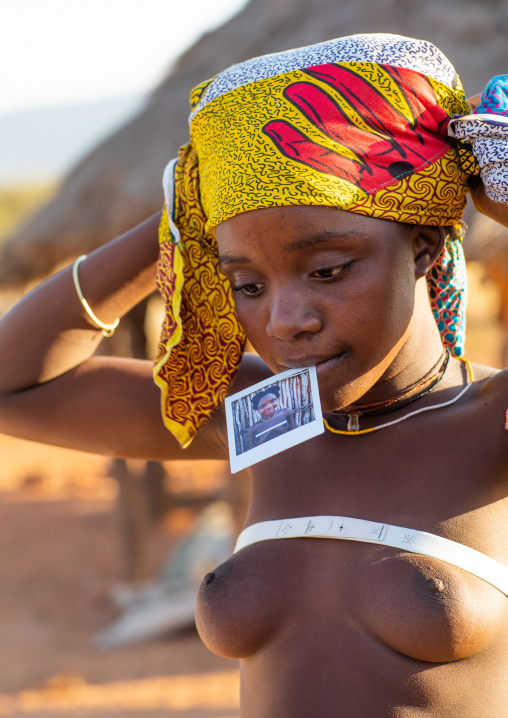 Nguendelengo tribe woman with a Polaroid of herself, Namibe Province, Capangombe, Angola