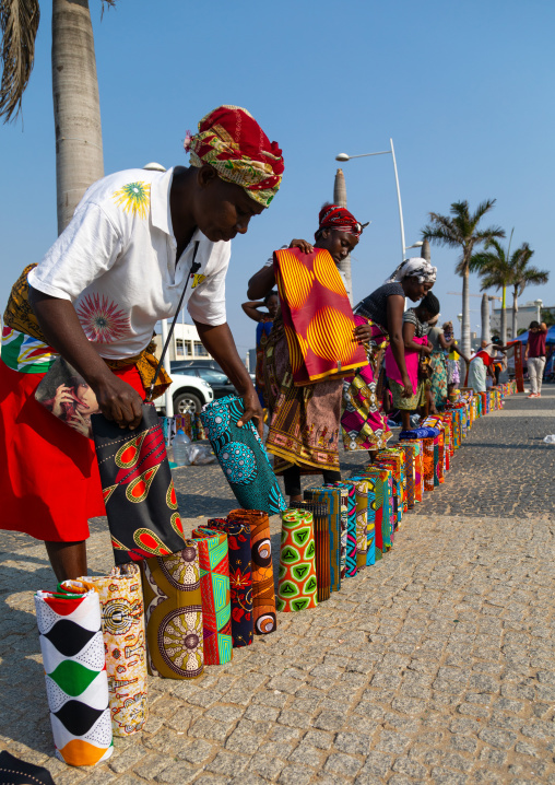 Angolan women selling wax print cloths in a street market, Luanda Province, Luanda, Angola
