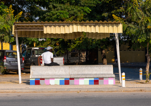 Angolan man waiting in a bus stop, Benguela Province, Lobito, Angola