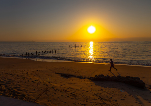 Man running on the beach at sunset, Benguela Province, Benguela, Angola