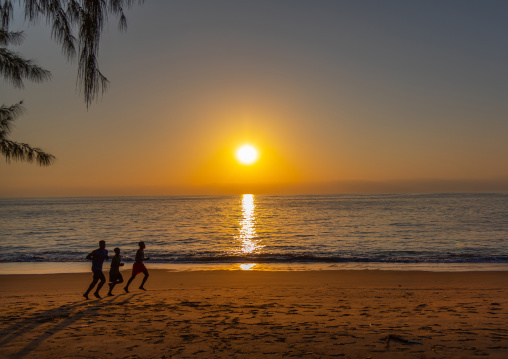 Men running on the beach at sunset, Benguela Province, Benguela, Angola
