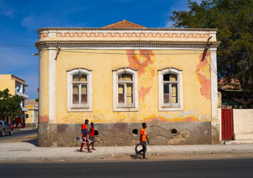 Children walking in front of an old portuguese colonial house, Namibe Province, Namibe, Angola