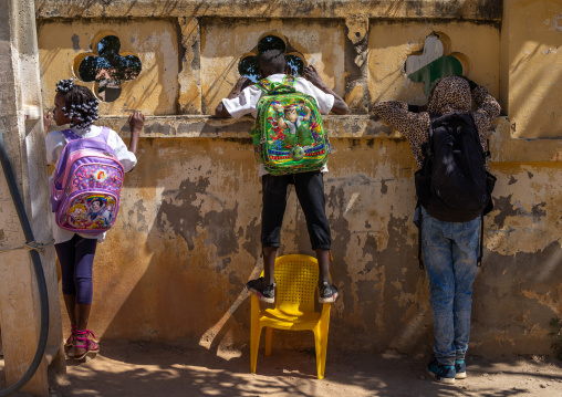 Angolan children looking inside their school from the street, Huila Province, Lubango, Angola