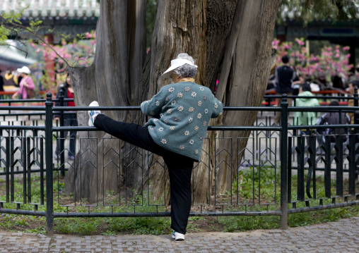Old Woman Doing Gymnastic In A Park, Beijing, China