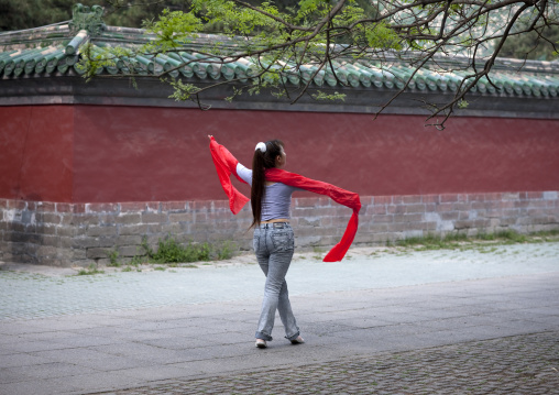 Woman Doing Gymnastic With Ribbons In A Park, Beijing, China