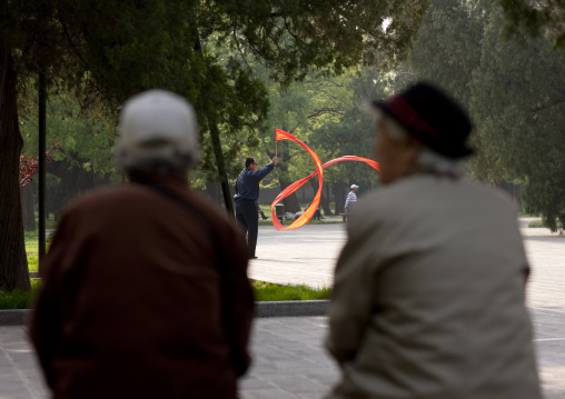 Old People Watching Gymnastic With Ribbons In A Park Beijing, China