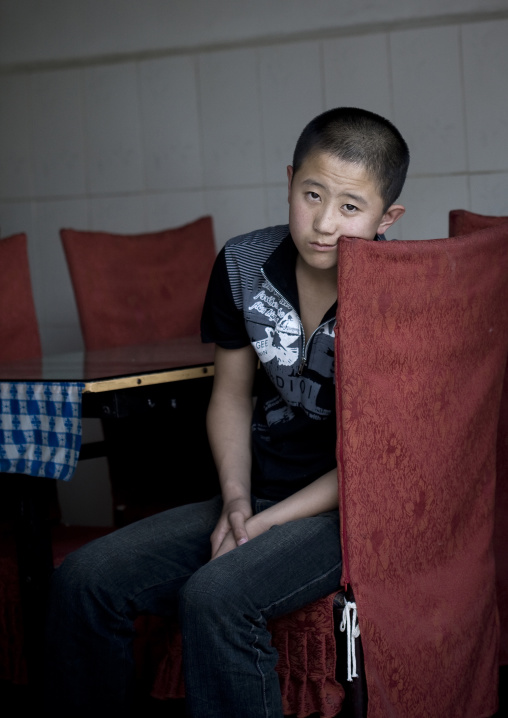 Kid Waiting For The Costumers In A Restaurant, Beijing, China