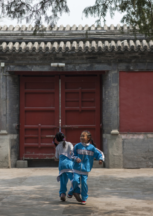 Two Kids Playing In A Courtyard, Beijing, China