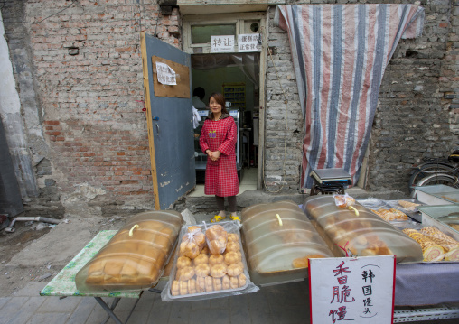 Woman Selliing Cakes In A Hutong Street, Beijing, China