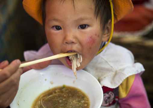 Chinese Baby Eating Noodles, Lijiang, Yunnan Province, China