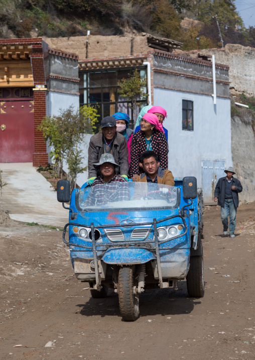 Tibetan workers on a three-wheeled chinese truck, Qinghai Province, Wayaotai, China