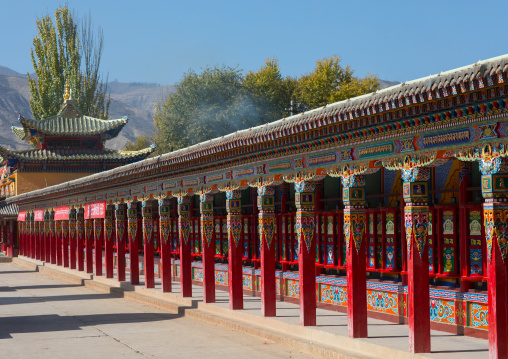 Beautifully painted and adorned prayer wheels in Wutun si monastery, Qinghai province, Wutun, China