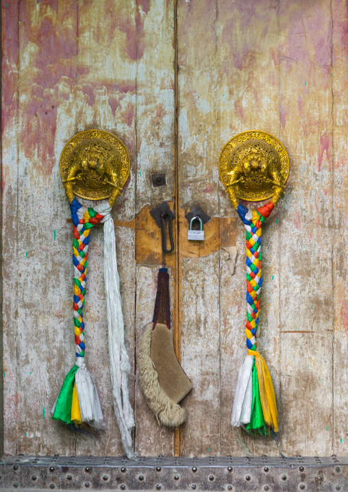 Ornate knockers on traditional buddhist door temple in Rongwo monastery, Tongren County, Longwu, China