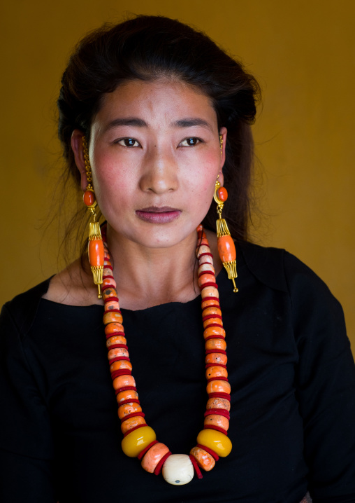 Portrait of a tibetan woman with a huge necklace, Qinghai province, Tsekhog, China