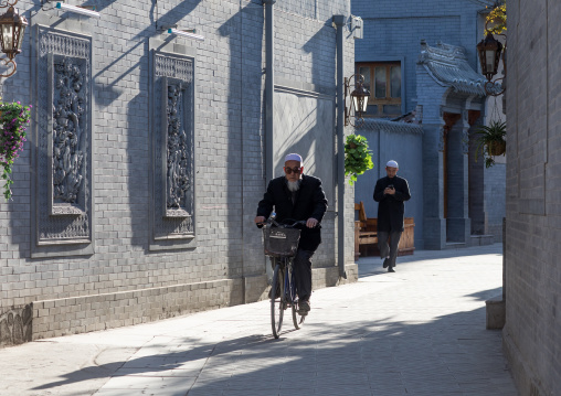 Hui muslim man riding a bicycle in the street
, Gansu province, Linxia, China