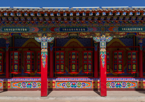 Beautifully painted and adorned prayer wheels in Wutun si monastery, Qinghai province, Wutun, China