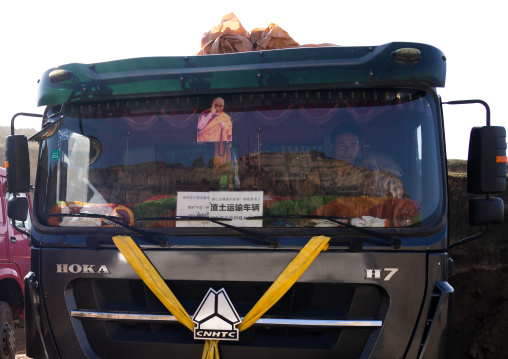 Dalai lama portrait on the windshield of a tibetan truck, Tongren County, Rebkong, China