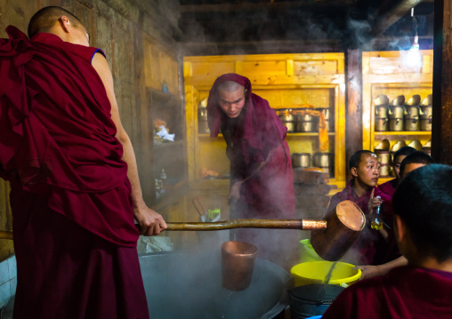 Monks in the kitchen of Rongwo monastery, Tongren County, Longwu, China