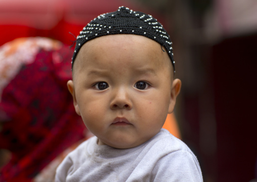 Baby with doppi hat, Hotan, Xinjiang Uyghur Autonomous Region, China