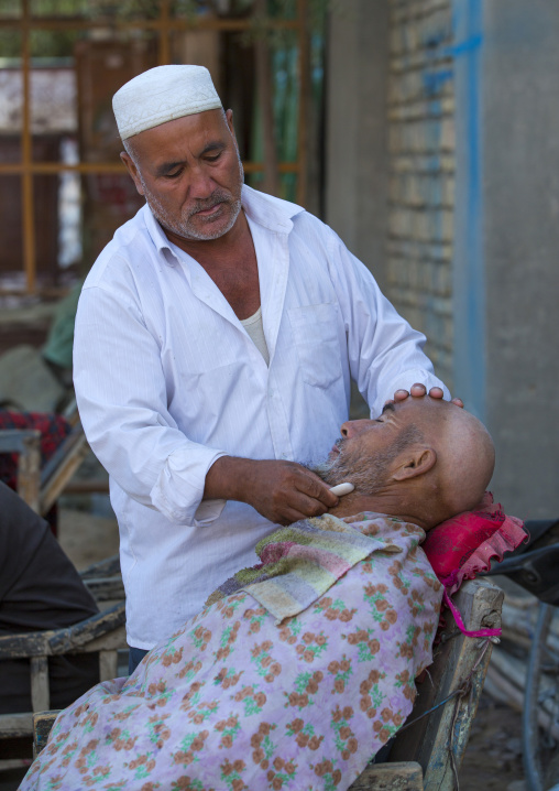 Uyghur Man Getting Shaved By A Barber At Serik Buya Market, Yarkand, Xinjiang Uyghur Autonomous Region, China
