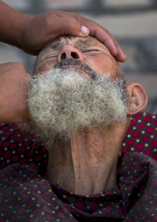 Uyghur Man Getting Shaved By A Barber At Serik Buya Market, Yarkand, Xinjiang Uyghur Autonomous Region, China