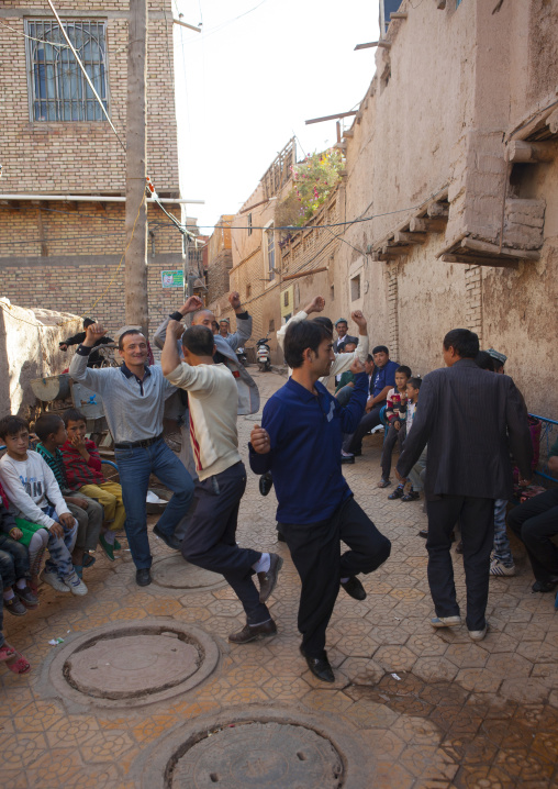 Men dancing in the street during a Wedding In Uyghur Family, Kashgar, Xinjiang Uyghur Autonomous Region, China