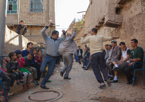 Men dancing in the street during a Wedding In Uyghur Family, Kashgar, Xinjiang Uyghur Autonomous Region, China