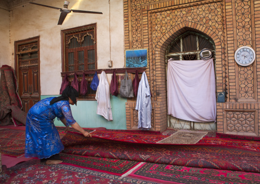 Uygur Woman Uncoiling The Carpets Of A Mosque, Old Town Of Kashgar, Xinjiang Uyghur Autonomous Region, China
