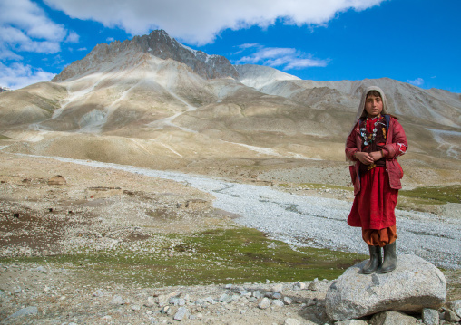 Wakhi nomad girl standing on a rock, Big pamir, Wakhan, Afghanistan