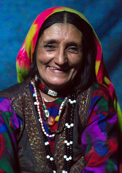 Portrait of a smiling afghan woman in pamiri traditional clothing, Badakhshan province, Khandood, Afghanistan