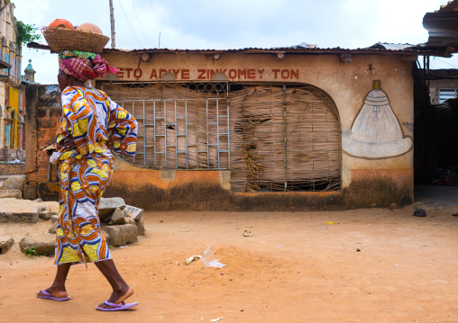 Benin, West Africa, Porto-Novo, woman passing in front of a voodoo temple