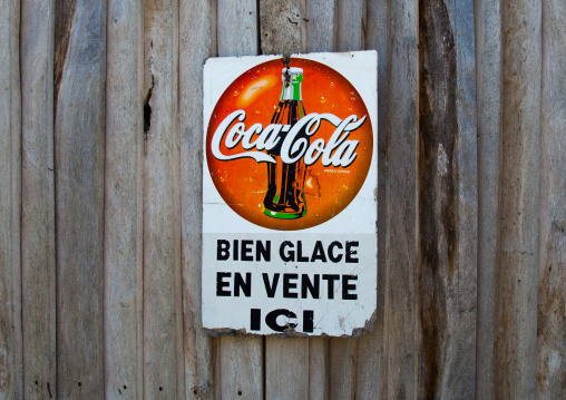 Benin, West Africa, Ganvié, a coca cola sign adverstising on a wooden door