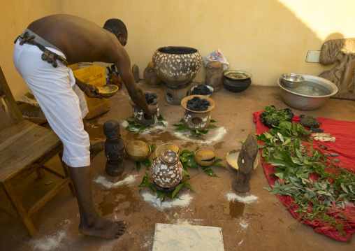 Benin, West Africa, Bonhicon, kagbanon bebe voodoo priest during a ceremony drawing white spots on a pot