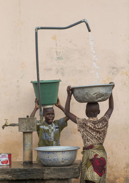 Benin, West Africa, Porto-Novo, children collecting water in the street