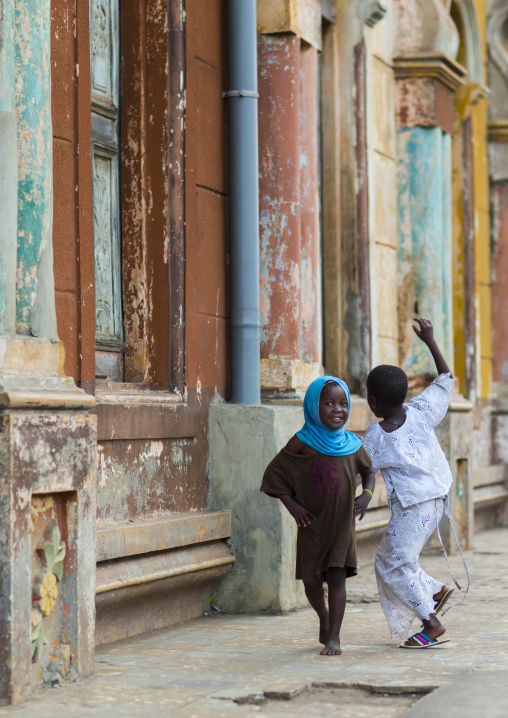 Benin, West Africa, Porto-Novo, children playing along the multicoloured great mosque