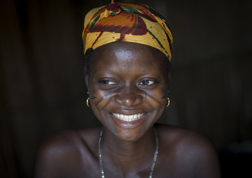Benin, West Africa, Onigbolo Isaba, smiling holi tribe woman covered with traditional facial tattoos and scars
