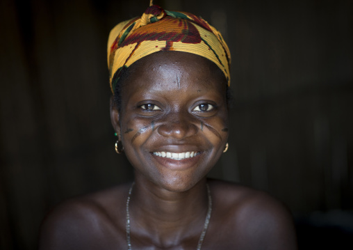 Benin, West Africa, Onigbolo Isaba, smiling holi tribe woman covered with traditional facial tattoos and scars