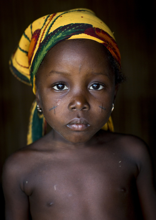 Benin, West Africa, Onigbolo Isaba, holi tribe girl with traditional facial tattoos and scars portrait