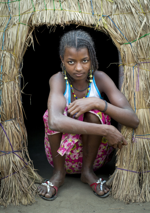 Benin, West Africa, Gossoue, a beautiful fulani peul tribe teenager at the entrance of her hut