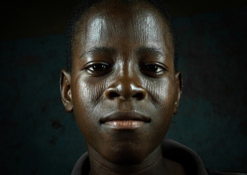 Benin, West Africa, Koussou, a somba tribe teenager with his face covered with linear scars