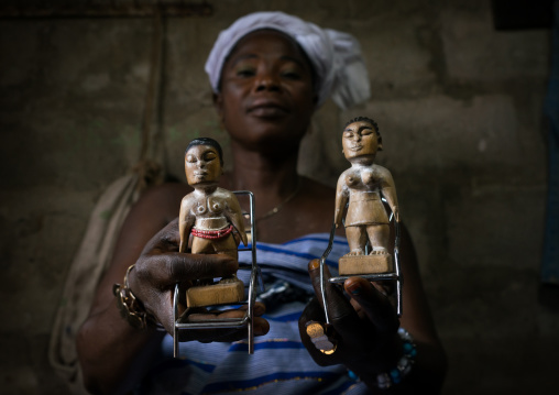 Benin, West Africa, Bopa, miss hounyoga with the wooden figures of her dead twins zinsou the boy and zinhoue the girl