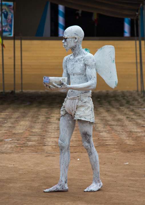 Benin, West Africa, Savalou, man disguised as an angel collecting money in the street